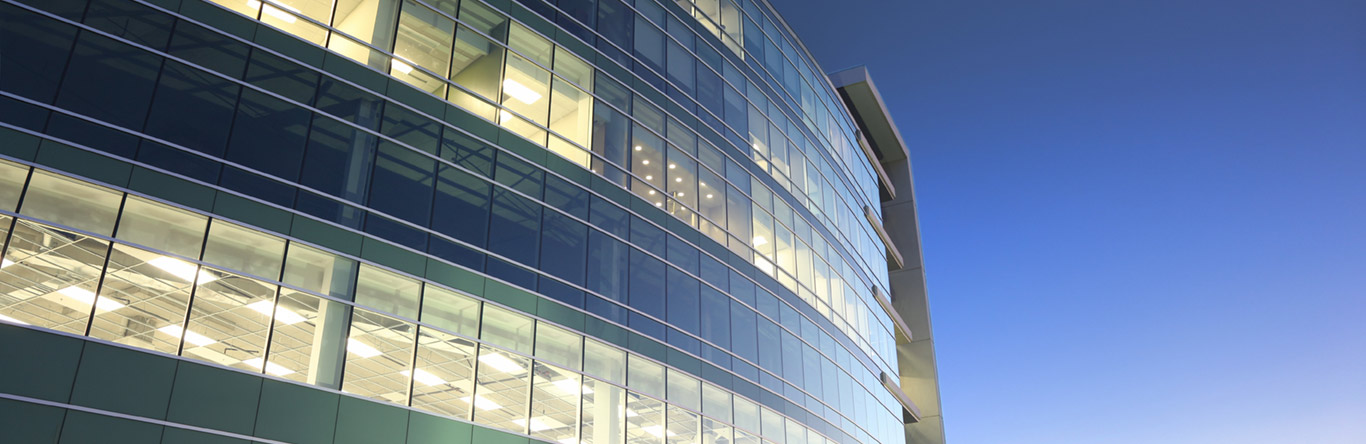 External view of building with internal lights on at dusk